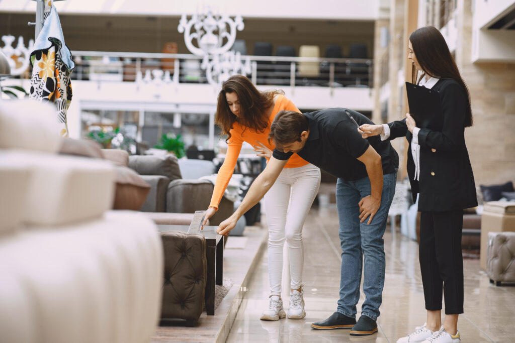 a couple shopping for furniture in store during off-season