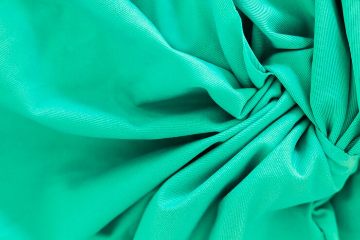 close up of crumpled polyester upholstery in dazzling green color