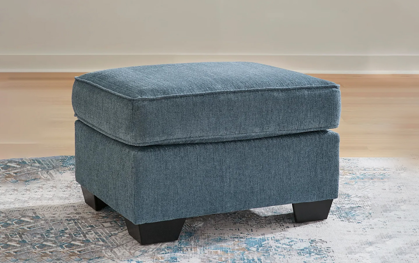 A blue upholstered modular storage ottoman