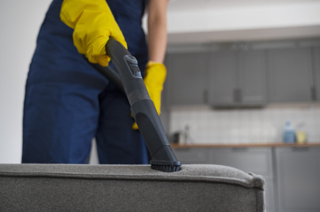 vacuuming upholstered furniture with a soft brush attachment