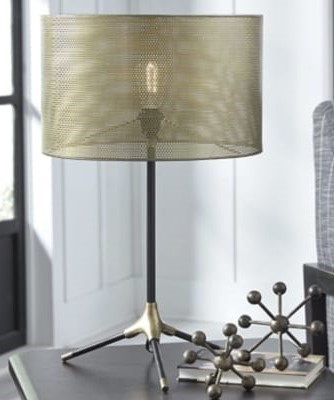 a soft, diffused bedside lamp in a home office guest room setup