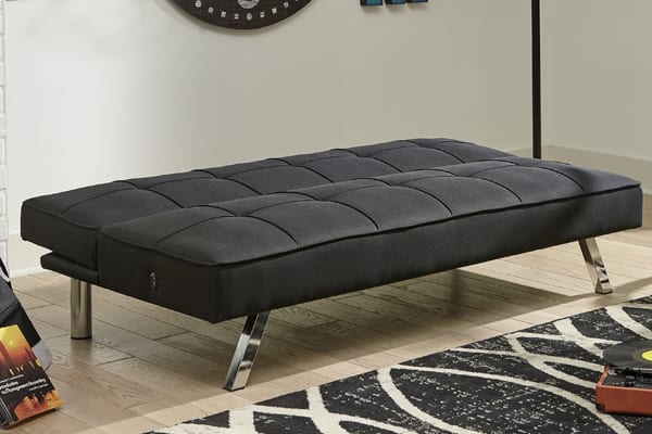 armless futon folded back to create a bed