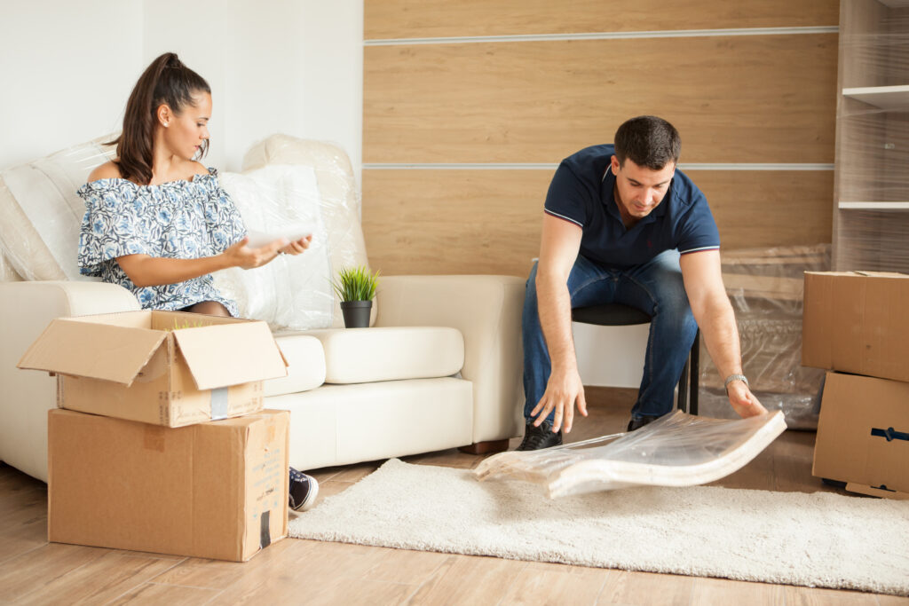 A couple checking the furniture parts from packages